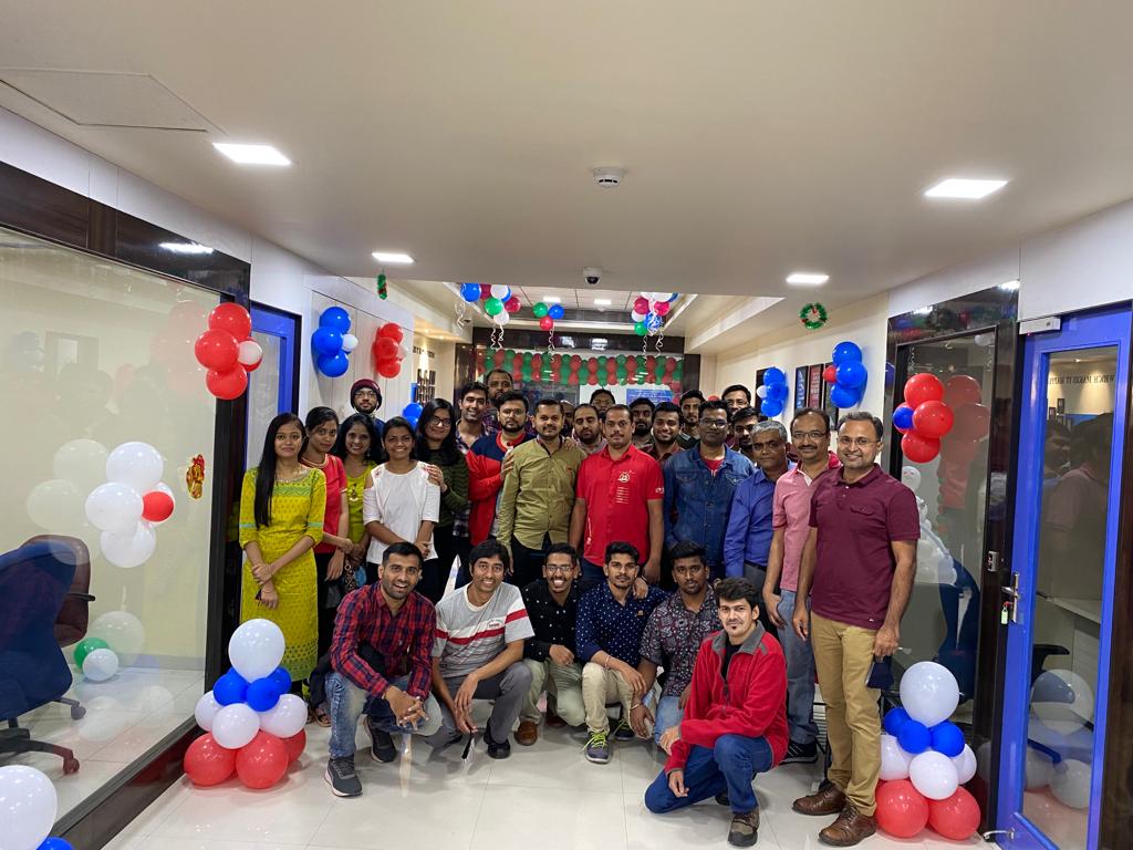 Group of 24/7 Software employees surrounded by balloons